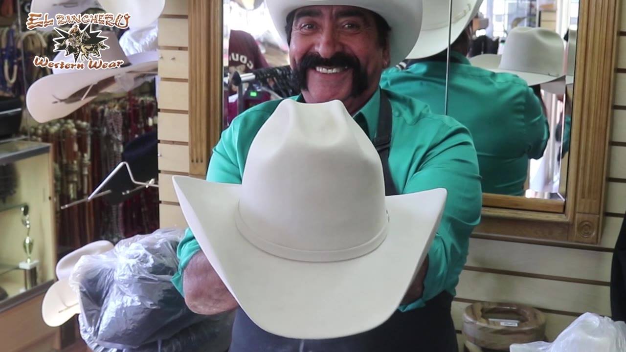 The owner of the store showing a white hat
